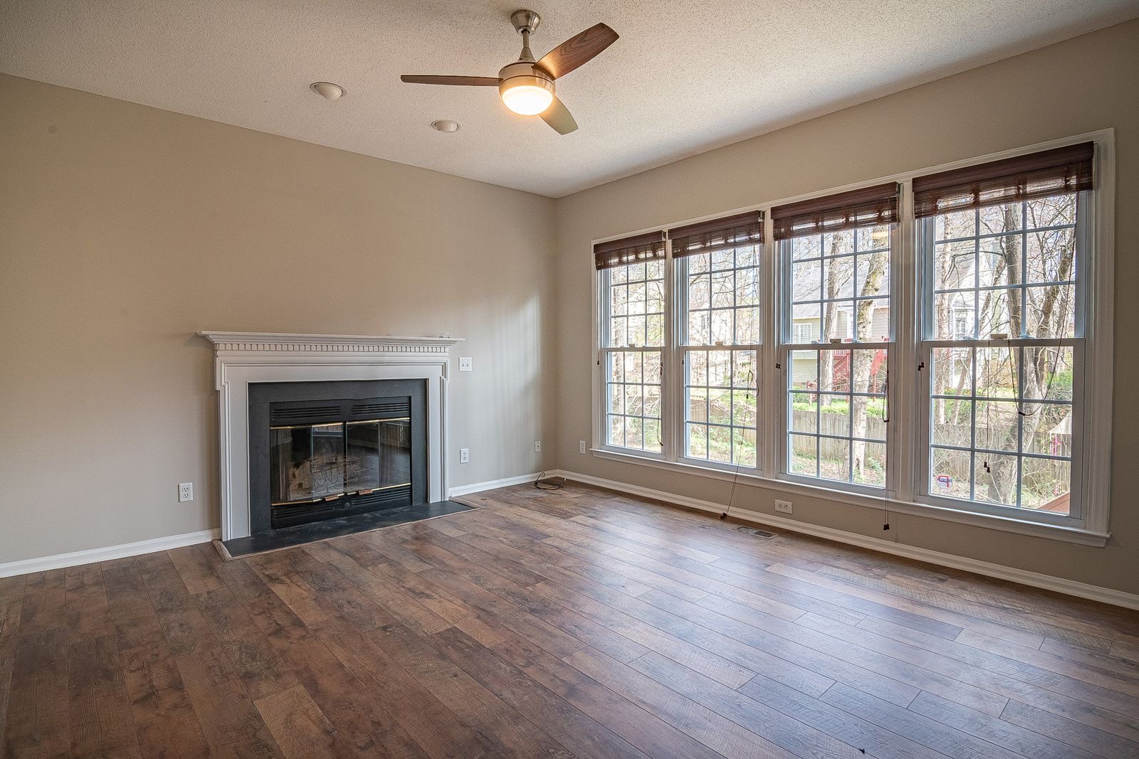 Bright family room with hardwood flooring and large windows